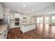 Spacious open concept kitchen featuring stainless appliances, granite countertops, and wood flooring at 4006 Fall Oak Ter, Fort Mill, SC 29707