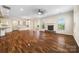 Expansive living area combining kitchen, dining, and living spaces with hardwood floors and fireplace at 4006 Fall Oak Ter, Fort Mill, SC 29707