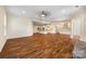 Open-concept living space featuring hardwood floors, a modern kitchen, and a cozy fireplace at 4006 Fall Oak Ter, Fort Mill, SC 29707