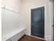 Entryway mudroom with a built-in bench, storage cabinets, coat hooks and a dark-colored door at 4006 Fall Oak Ter, Fort Mill, SC 29707