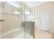 Shower with glass enclosure, shower seat, tile surround and shower head at 4006 Fall Oak Ter, Fort Mill, SC 29707