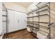 Walk-in closet with wood floors, adjustable shelves, and clothes storage system at 4006 Fall Oak Ter, Fort Mill, SC 29707