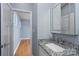 Modern bathroom with granite countertops, decorative mirror and open doorway at 406 Williamson St, Fort Mill, SC 29715