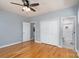 Bedroom boasts hardwood floors, light blue walls, ceiling fan and double door closet at 406 Williamson St, Fort Mill, SC 29715