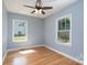 Bedroom with hardwood floors, light blue walls, and natural light from the windows at 406 Williamson St, Fort Mill, SC 29715