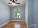 Bedroom with hardwood floors, light blue walls, a window and single door closet at 406 Williamson St, Fort Mill, SC 29715