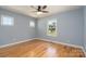 Bedroom boasts hardwood floors, light blue walls, and natural light from the windows at 406 Williamson St, Fort Mill, SC 29715
