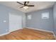 Bedroom featuring hardwood floors, light blue walls, ceiling fan, and natural light from windows at 406 Williamson St, Fort Mill, SC 29715