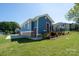 Beautiful blue home with a red door, a well-manicured lawn, and a new driveway at 406 Williamson St, Fort Mill, SC 29715