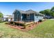 Rear view of the house featuring a well-maintained lawn and a wooden deck, ideal for outdoor enjoyment at 406 Williamson St, Fort Mill, SC 29715