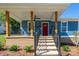 Inviting front porch with wooden pillars, black railings, and a vibrant red door, creating a welcoming entrance at 406 Williamson St, Fort Mill, SC 29715