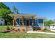 Inviting front porch with stained wood columns and a red door, enhanced by professionally landscaped flower beds at 406 Williamson St, Fort Mill, SC 29715