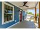 Charming covered porch with wood columns, black railings, and a vibrant red door, offering a cozy outdoor space at 406 Williamson St, Fort Mill, SC 29715