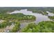Breathtaking aerial view of a lake community with waterfront homes surrounded by lush trees at 4120 Spring Cove Way, Belmont, NC 28012