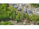 Aerial view of a stunning home nestled among lush trees with private boat docks on the lake at 4120 Spring Cove Way, Belmont, NC 28012