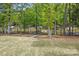 Beautiful lake view from the backyard with mature trees and a black aluminum fence at 4120 Spring Cove Way, Belmont, NC 28012
