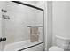 This bathroom features a glass shower door, tiled walls, and modern fixtures, providing a clean, contemporary feel at 4120 Spring Cove Way, Belmont, NC 28012