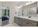 Bright bathroom with double vanity and a mirror; view of the bedroom at 4120 Spring Cove Way, Belmont, NC 28012
