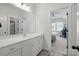 Bright bathroom featuring double vanity, a mirror, and an entrance to a bedroom at 4120 Spring Cove Way, Belmont, NC 28012