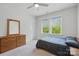 Inviting bedroom with a dresser, bed, and natural light from the window at 4120 Spring Cove Way, Belmont, NC 28012