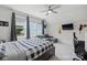 Bright bedroom featuring a bed, sofa, ceiling fan, and natural light from large windows at 4120 Spring Cove Way, Belmont, NC 28012