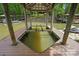 Boat dock features a lift for watercraft and offers deep water access, surrounded by serene lake views and lush landscaping at 4120 Spring Cove Way, Belmont, NC 28012