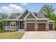 Charming craftsman-style home with a welcoming porch, stone accents, and a three-car garage at 4120 Spring Cove Way, Belmont, NC 28012