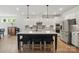 Bright kitchen features a large island with seating and stainless steel appliances at 4120 Spring Cove Way, Belmont, NC 28012