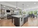 Open concept kitchen features an island with bar seating and an adjacent living room at 4120 Spring Cove Way, Belmont, NC 28012