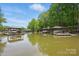 Picturesque lake view showcasing private covered boat slips and waterfront living at 4120 Spring Cove Way, Belmont, NC 28012