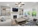 Bright living room with a fireplace and built-in shelves, with a large window at 4120 Spring Cove Way, Belmont, NC 28012