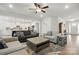 Open-concept living room with hardwood floors, stylish furniture, and a view of the kitchen at 4120 Spring Cove Way, Belmont, NC 28012