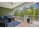 Relax on this screened porch with comfortable seating, wooden floors, and a view of the lush surrounding landscape at 4120 Spring Cove Way, Belmont, NC 28012