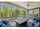 Enjoy the outdoors from this screened porch, featuring ample seating, a ceiling fan, and scenic nature views at 4120 Spring Cove Way, Belmont, NC 28012