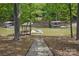Charming waterfront area with a stone pathway leading to private boat docks surrounded by lush greenery and calm waters at 4120 Spring Cove Way, Belmont, NC 28012