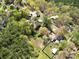 A captivating aerial view showcasing the property's setting within a verdant neighborhood with mature trees and landscaping at 422 Sherrill Farm Rd, Lincolnton, NC 28092