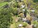 Expansive aerial view of a lush property with mature trees and a fenced-in area, offering privacy and serenity at 422 Sherrill Farm Rd, Lincolnton, NC 28092