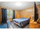 Comfortable bedroom featuring wood paneling, a bed and storage dresser at 422 Sherrill Farm Rd, Lincolnton, NC 28092