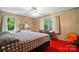 Comfortable bedroom features wood paneling, a ceiling fan and windows with natural light at 422 Sherrill Farm Rd, Lincolnton, NC 28092