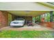 Carport with brick columns and a white car, red mower, and ladder at 422 Sherrill Farm Rd, Lincolnton, NC 28092