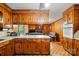 Spacious kitchen opens to a living area, featuring wood cabinets, and a convenient breakfast bar at 422 Sherrill Farm Rd, Lincolnton, NC 28092