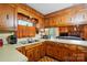 Charming kitchen featuring warm wood cabinets, retro accents, and a view into the cozy living area at 422 Sherrill Farm Rd, Lincolnton, NC 28092