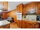 Functional kitchen showcases vintage wood cabinetry, oven, and cooktop adjacent to the living space at 422 Sherrill Farm Rd, Lincolnton, NC 28092