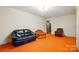Bright living room with orange carpet featuring comfortable seating and neutral colored walls at 422 Sherrill Farm Rd, Lincolnton, NC 28092