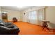 Inviting living room with orange carpet, a fireplace, and large windows at 422 Sherrill Farm Rd, Lincolnton, NC 28092