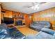 Inviting living room with brick fireplace, wood paneling, and comfortable seating at 422 Sherrill Farm Rd, Lincolnton, NC 28092