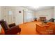 Spacious living room featuring a fireplace, neutral walls, and unique orange carpeting at 422 Sherrill Farm Rd, Lincolnton, NC 28092