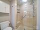 Bathroom featuring glass shower with tiled walls and a built-in seat at 4754 Polo Gate Blvd, Charlotte, NC 28216