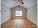 Bright bedroom featuring vaulted ceilings, one window, and wood-look floors at 4754 Polo Gate Blvd, Charlotte, NC 28216