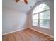 Bright bedroom showcasing a large arched window, providing ample natural light and a peaceful atmosphere at 4754 Polo Gate Blvd, Charlotte, NC 28216